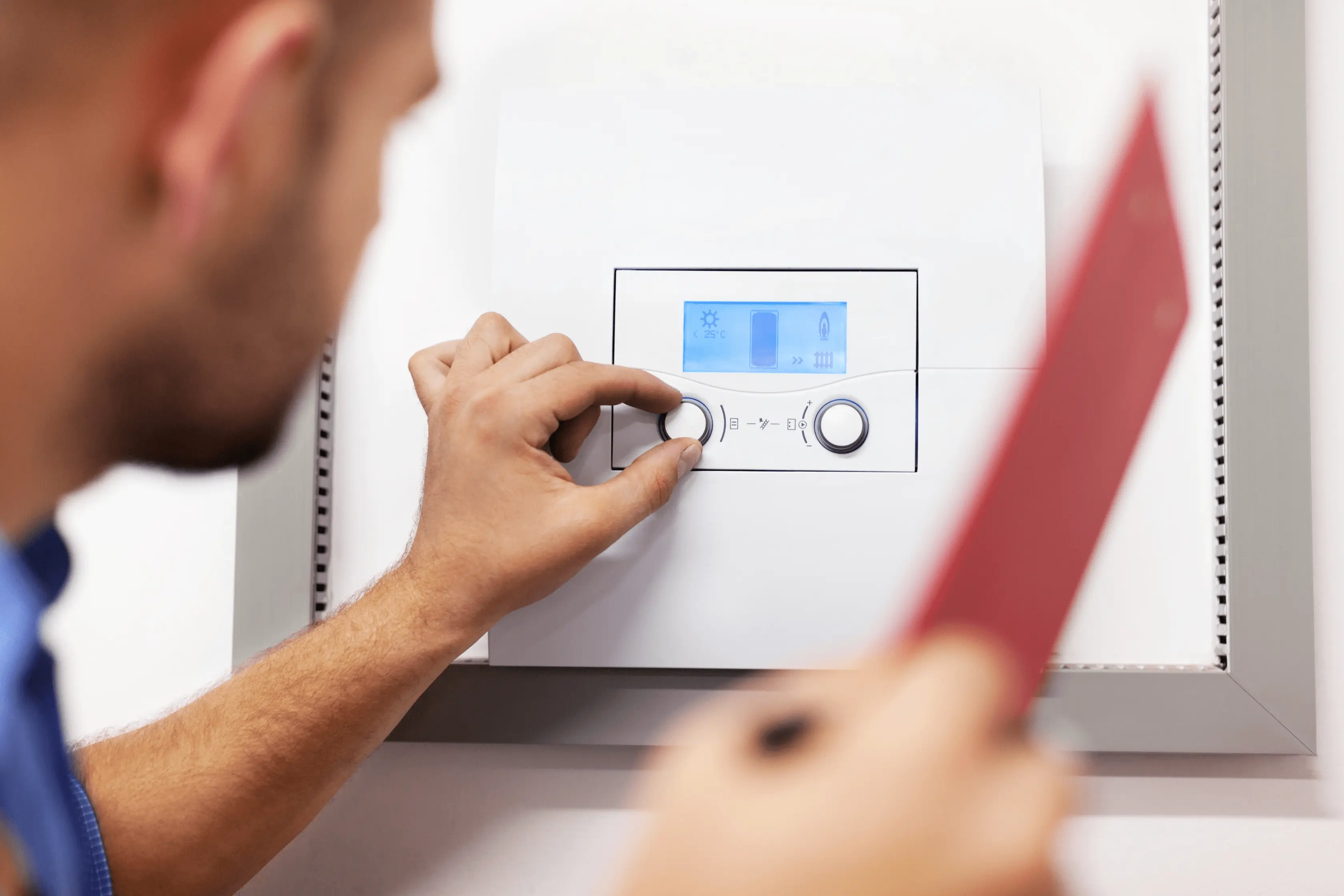 Homeowner Checking Central Heating Temperature In Home